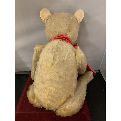 101 - A VINTAGE TEDDY BEAR WITH RED BOW (BELIEVED 1920S)