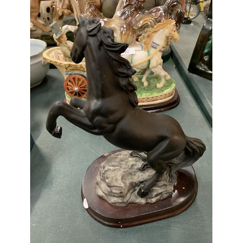 121 - A 'CAPACINO' REARING BLACK HORSE ON A WOODEN PLINTH