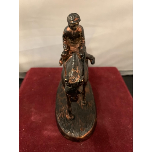 90 - A SPELTER FIGURE OF A JOCKEY ON A RACE HORSE