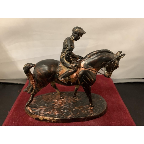 90 - A SPELTER FIGURE OF A JOCKEY ON A RACE HORSE