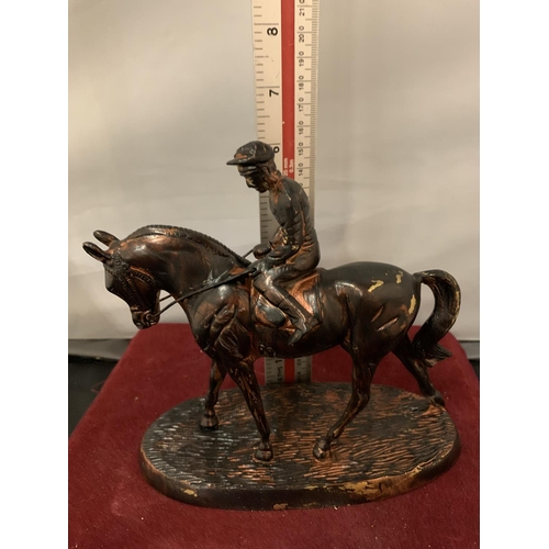 90 - A SPELTER FIGURE OF A JOCKEY ON A RACE HORSE