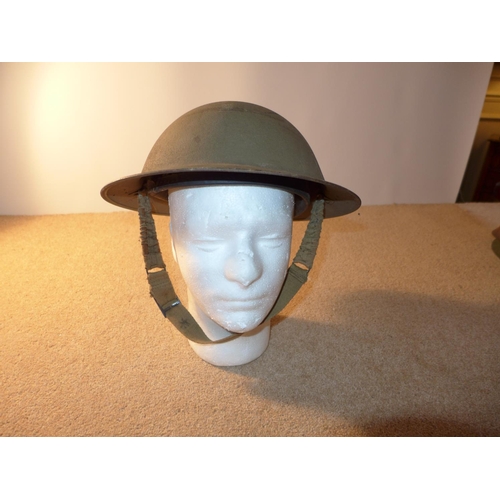 336 - A WORLD WAR II PERIOD BRITISH STEEL HELMET AND LINER