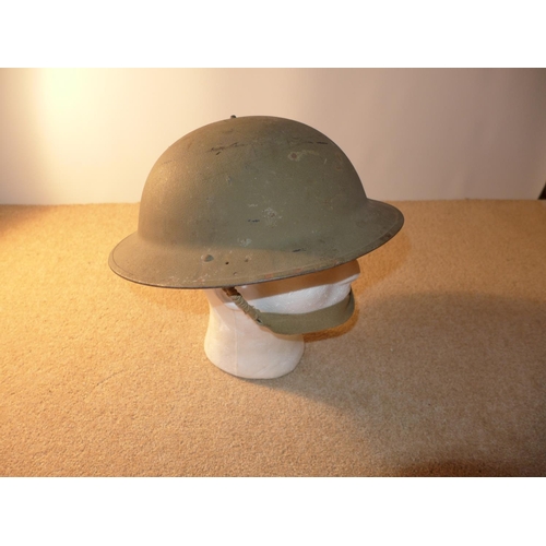 339 - A WORLD WAR II PERIOD BRITISH STEEL HELMET AND LINER