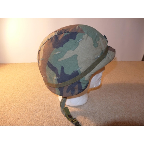 342 - AN ARMY HELMET, WITH CAMOFLAGE COVER