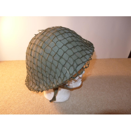 344 - A BRITISH ARMY STEEL HELMET WITH LINING AND NET COVER TOGETHER WITH A CAMOFLAGE COVER