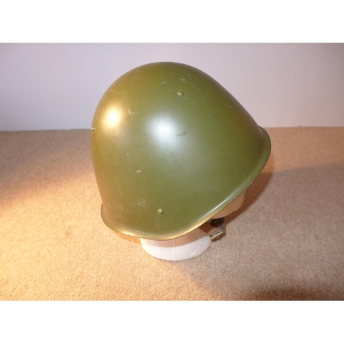 374 - A GREEN PAINTED STEEL HELMET AND LINER