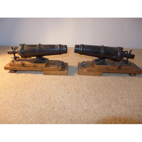 378 - A PAIR OF MODEL CARRONADES, 21CM LONG, CAST IRON BARRELS MOUNTED ON A SLIDING OAK FRAME, LENGTH 31CM... 