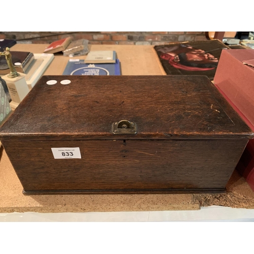 833 - A VINTAGE WOODEN STORAGE BOX WITH CLASP