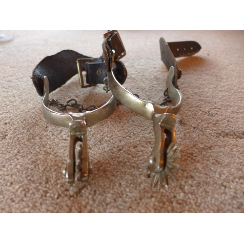 472 - A PAIR OF SPURS WITH LEATHER STRAPS