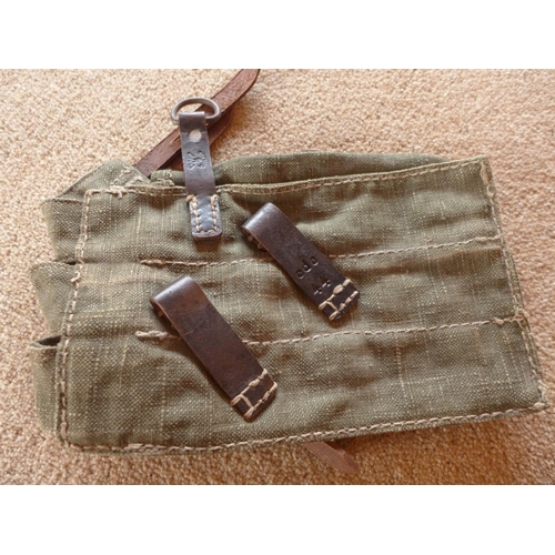 485 - A THREE SECTION MAGAZINE POUCH, THE LEATHER STRAPS MARKED WITH AN EAGLE AND SWASTIKA