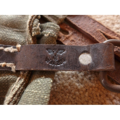 485 - A THREE SECTION MAGAZINE POUCH, THE LEATHER STRAPS MARKED WITH AN EAGLE AND SWASTIKA