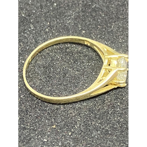 504 - A 9 CARAT GOLD RING WITH A HEART SHAPED CLEAR STONE