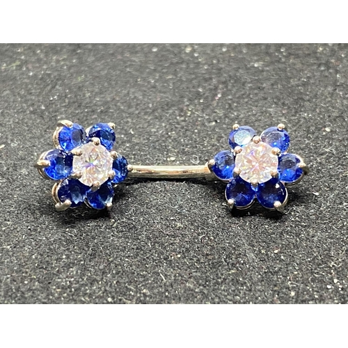 549 - TWO SILVER BELLY BUTTON BARS WITH COLOURED STONE FLOWER DESIGN