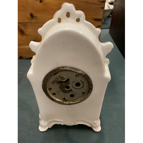 102 - A DECORATIVE CERAMIC MANTEL CLOCK