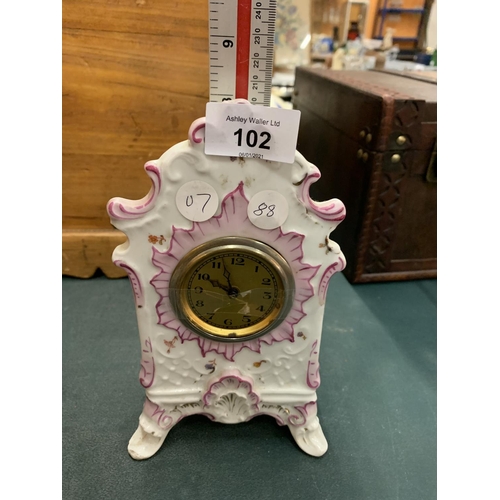 102 - A DECORATIVE CERAMIC MANTEL CLOCK