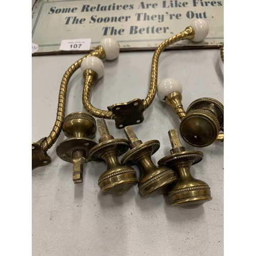 107 - AN ASSORTMENT OF METAL WARE TO INCLUDE COAT HOOKS AND DOOR KNOBS ETC