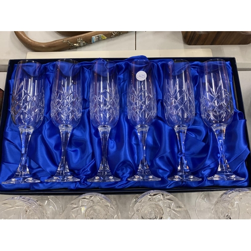 113 - AN ASSORTMENT OF CUT GLASSES TO INCLUDE SIX BOXED CHAMPAGNE FLUTES ETC