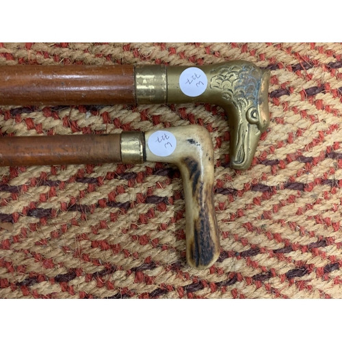 145 - TWO VINTAGE WALKING STICKS TO INCLUDE ONE WITH A HEAVY BRASS EAGLES HEAD HANDLE