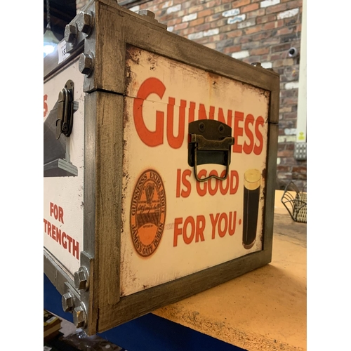 183 - A TWIN HANDLED TRUNK DECORATED WITH 'GUINNESS' ADVERTISING MATERIAL