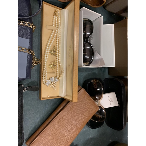 198 - AN ASSORTMENT OF LADIES ITEMS TO INCLUDE CLUTCH BAGS, PURSES AND SUN GLASSES ETC