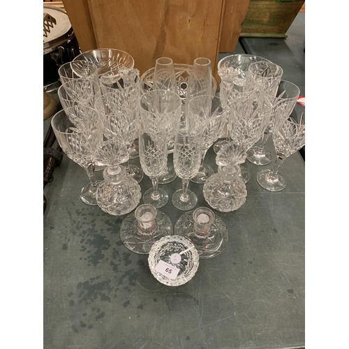 65 - A LARGE QUANTITY OF GLASS WARE TO INCLUDE TWELVE WINE GLASSES AND BOWLS ETC