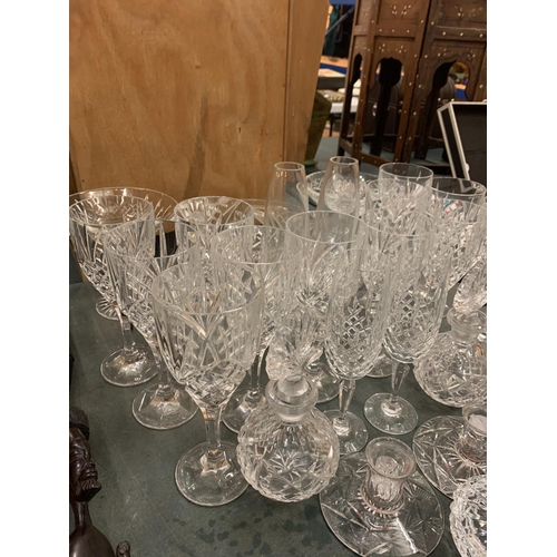 65 - A LARGE QUANTITY OF GLASS WARE TO INCLUDE TWELVE WINE GLASSES AND BOWLS ETC