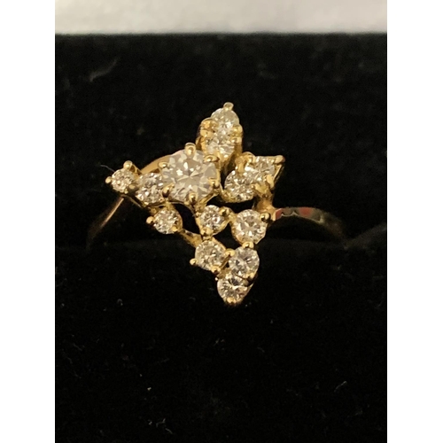 588 - A DECORATIVE ABSTRACT DESIGN 18 CARAT GOLD DIAMOND CLUSTER RING 3.47G APPROXIMATELY 60 PTS SIZE: O