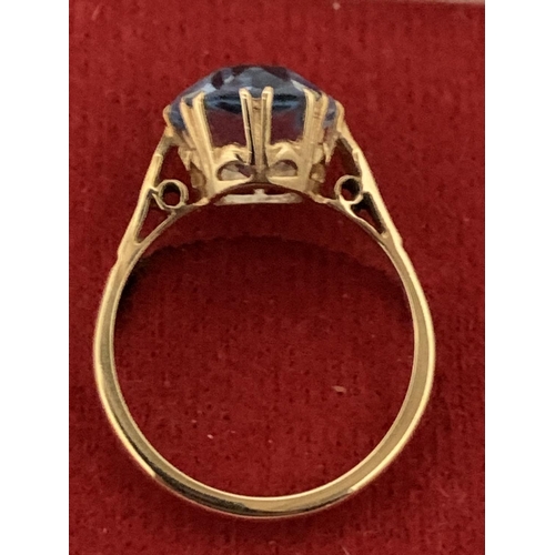 592 - A 9 CARAT GOLD RING WITH A  PALE BLUE STONE 3.21G