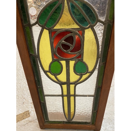 623 - A WOODEN FRAMED ORNATE STAINED GLASS WALL HANGING WITH CHAIN