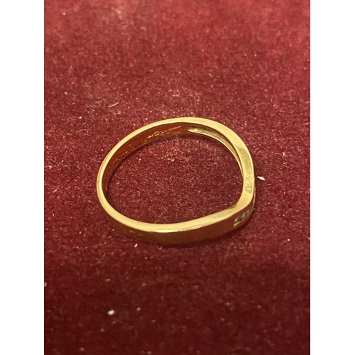 502 - A 9 CARAT GOLD WISHBONE STYLE RING WITH SEVEN DIAMONDS