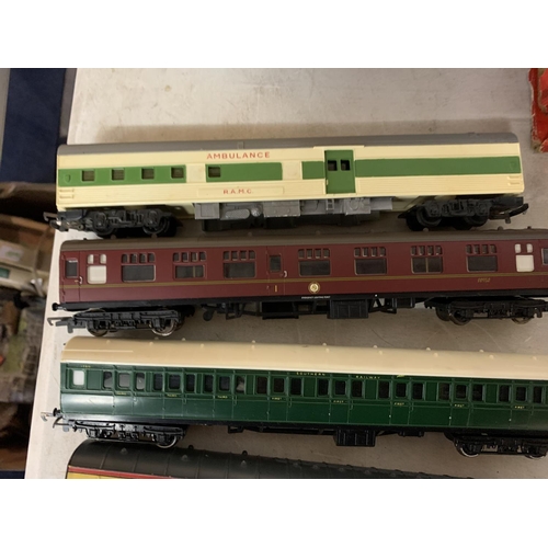 221 - FIVE OO GAUGE PASSENGER CARRIAGES TO INCLUDE AN AMBULANCE AND A HOGWARTS RAILWAYS ETC