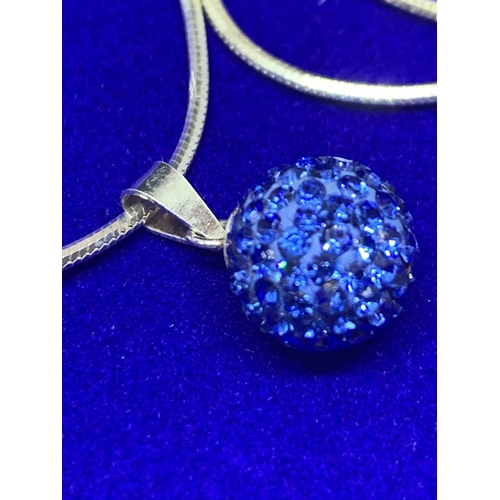 513 - A SILVER CHAIN MARKED 925 WITH A BLUE CRYSTAL BALL PENDANT IN A PRESENTATION BOX