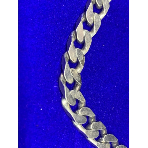 517 - A HEAVY SILVER BRACELET WITH FLAT CURB LINK DESIGN MARKED 925 IN A PRESENTATION BOX