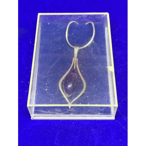 523 - A SILVER NECKLACE WITH PENDANT MARKED 925 WITH A PURPLE STONE WITH A PRESENTATION BOX