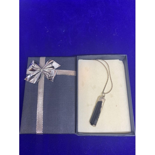 534 - A SILVER NECKLACE MARKED 925 AND A BLACK AND SILVER PENDANT WITH A PRESENTATION BOX