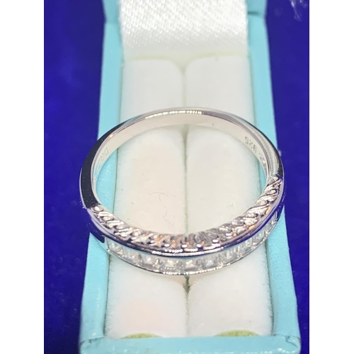 542 - A SILVER RING MARKED 925 WITH INLINE CLEAR STONES SIZE N IN A PRESENTATION BOX