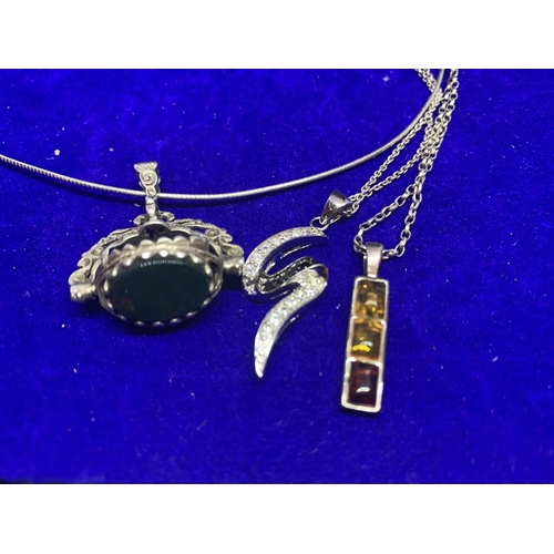 566 - FOUR SILVER NECKLACES TO INCLUDE PENDANTS WITH THREE STONES, S SHAPE, INGOT YELLOW STONES ETC