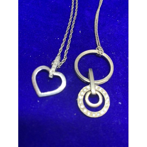 583 - FOUR SILVER NECKLACES WITH PENDANTS