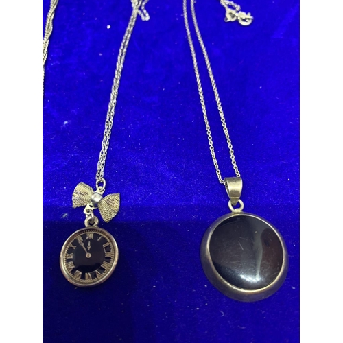 598 - FOUR SILVER NECKLACES WITH PENDANTS TO INCLUDE A CLOCK, BLACKSTONE, RING ETC