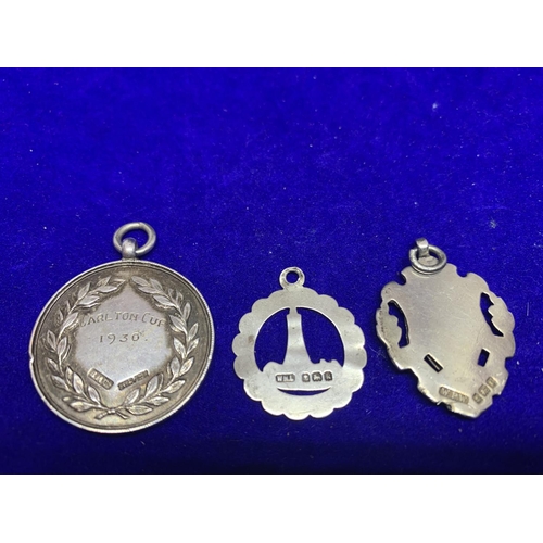 616 - THREE HALLMARKED SILVER ALBERT FOBS TO INCLUDE A 1930 CHARLTON CUP