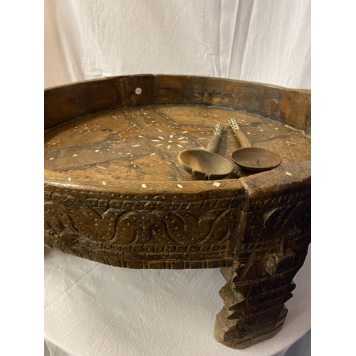 2 - A VERY LARGE HEAVILY CARVED 19TH CENTURY AFGHAN TRIBAL BOWL ON FOUR LEGS AND A PAIR OF WOODEN SERVER... 