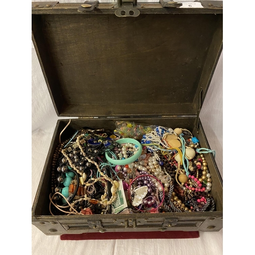 6 - A LARGE ORNATE WOODEN AND FAUX LEATHER BOX CONTAINING A COLLECTION OF COSTUME JEWELLERY