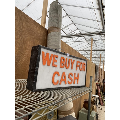 1219 - AN ILLUMINATED 'WE BUY FOR CASH' SIGN