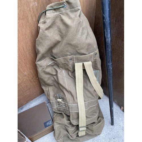 1253 - A VINTAGE CASED FISHING ROD AND A LARGE ARMY STYLE SACK