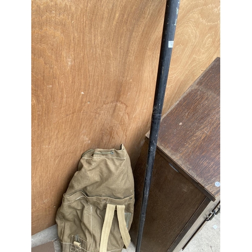 1253 - A VINTAGE CASED FISHING ROD AND A LARGE ARMY STYLE SACK