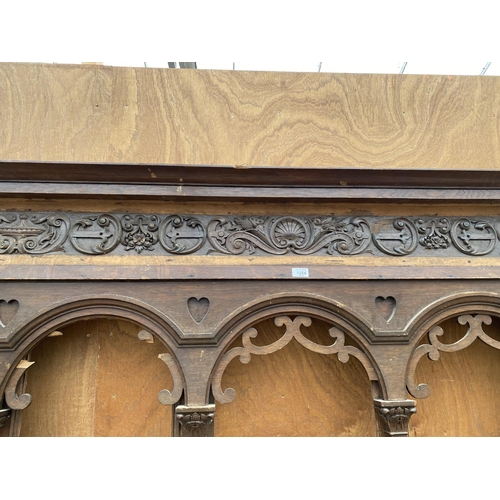 1254 - A LARGE ORNATE WOODEN FIRE SURROUND WITH DECORATIVE CARVING