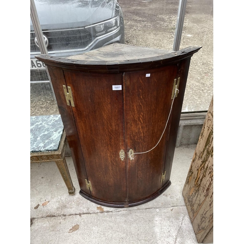 1907 - A GEORGE III OAK BOWFRONTED CORNER CUPBOARD, 29