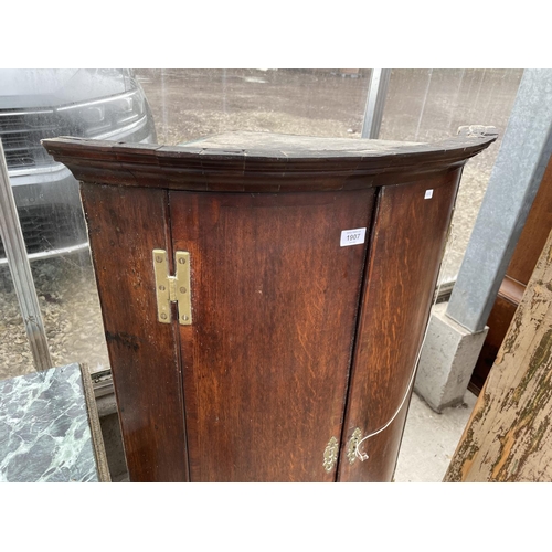 1907 - A GEORGE III OAK BOWFRONTED CORNER CUPBOARD, 29