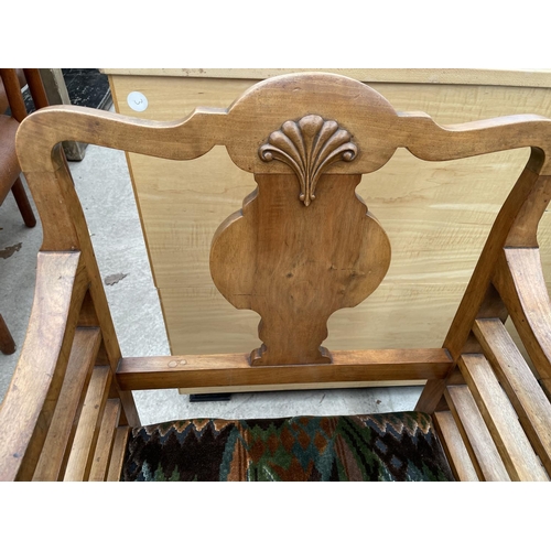 1908 - AN EARLY 20TH CENTURY WALNUT FRAMED LOW ELBOW CHAIR ON TURNED BULBOUS LEGS AND SCROLL FEET