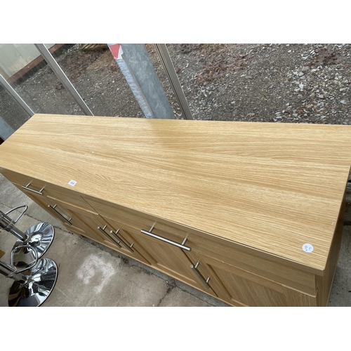 1918 - A MODERN LIGHT OAK EFFECT SIDEBOARD ENCLOSING TWO DRAWERS AND FOUR CUPBOARDS, 64